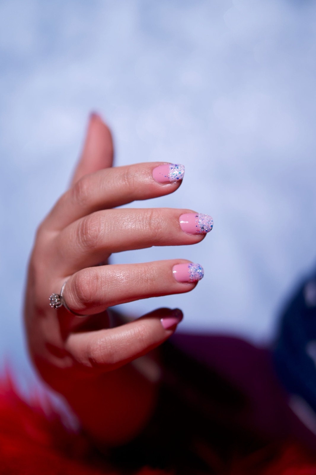 Pink glitter gradient nail design with hand-painted accent nails