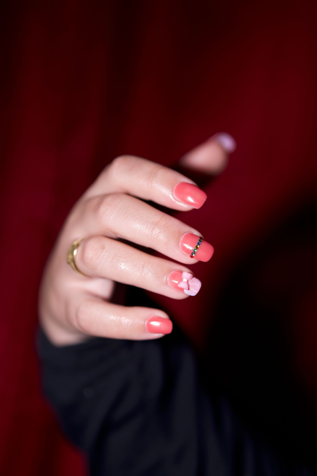 Custom hand-painted gel nail art with a 3D bow charm and crystal detail created at V Best Nail Art in Berkeley CA