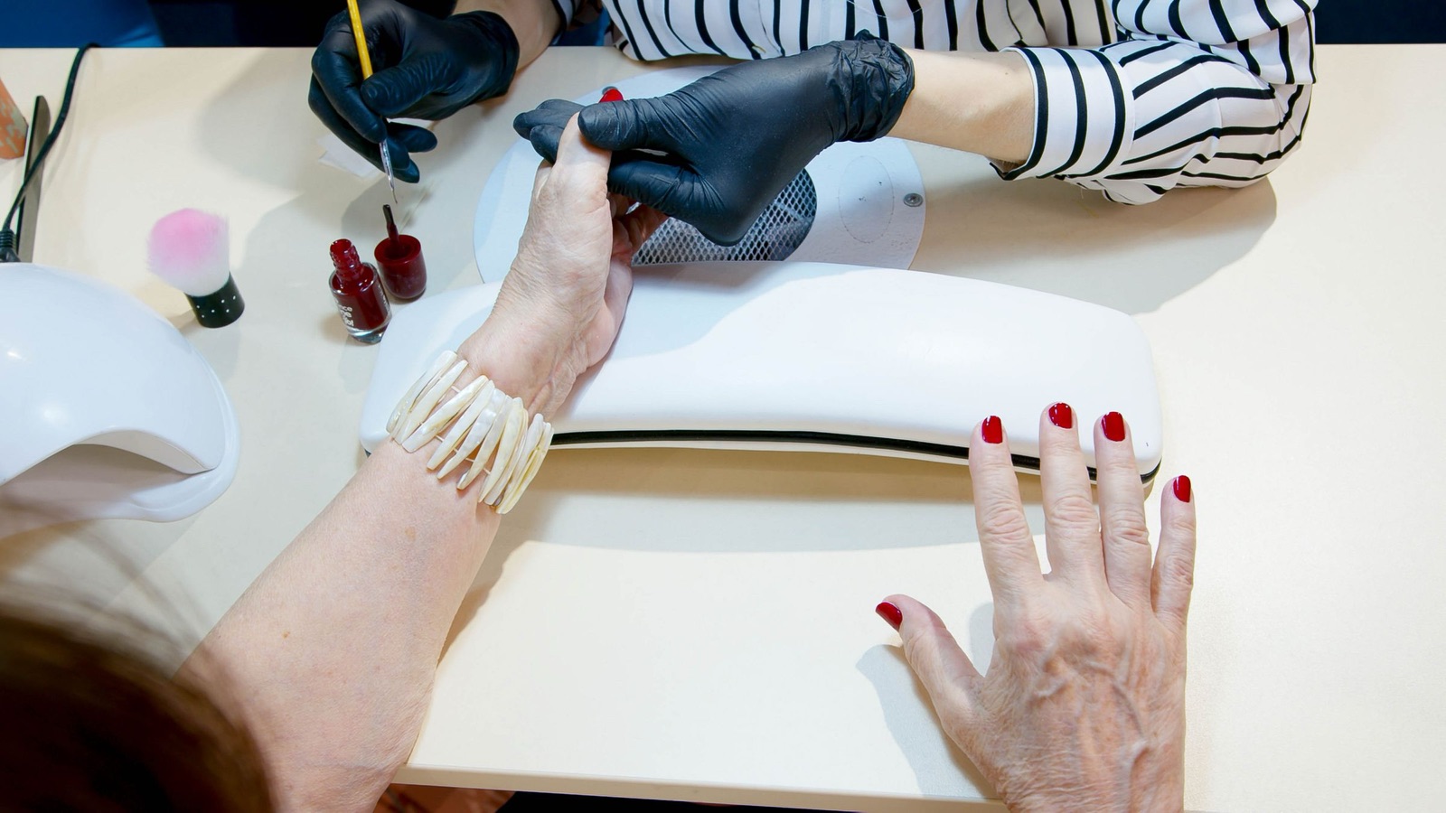 Nail artist carefully working on a client's nails at a private studio in Berkeley California